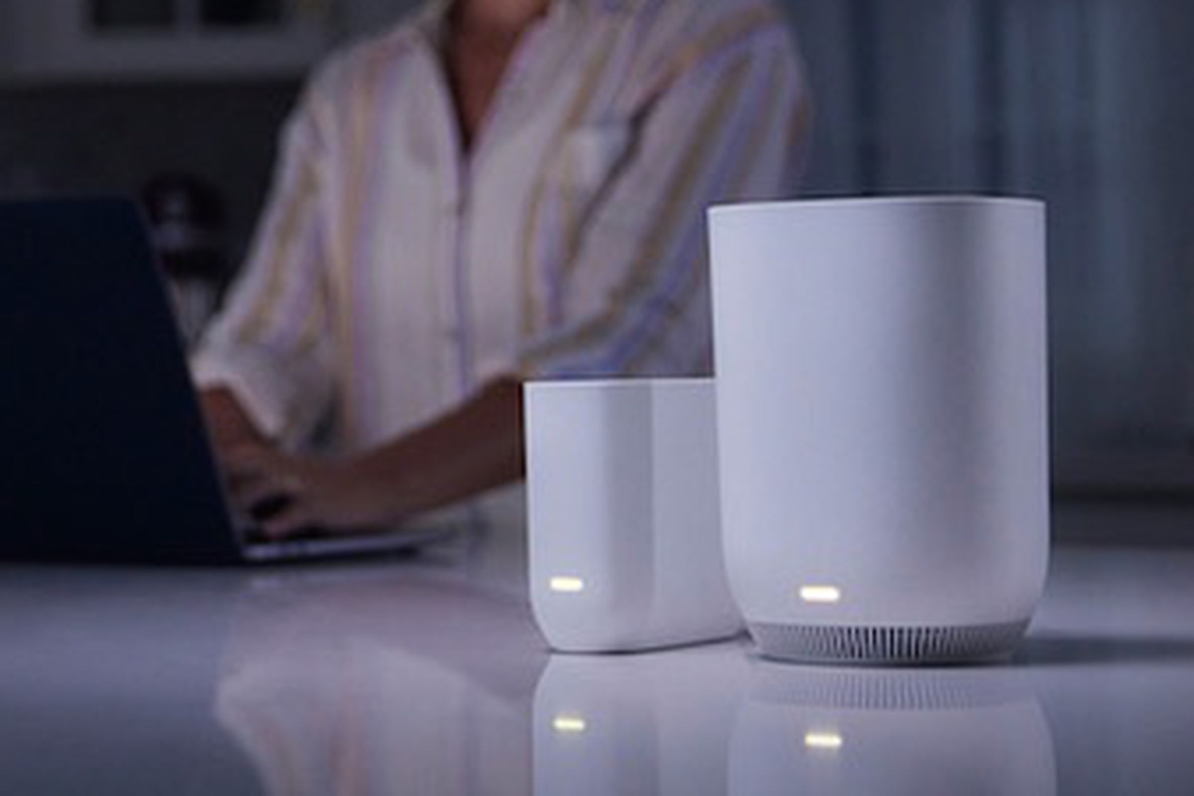 The Xfinity Storm-Ready WiFi on a table in a dark kitchen.