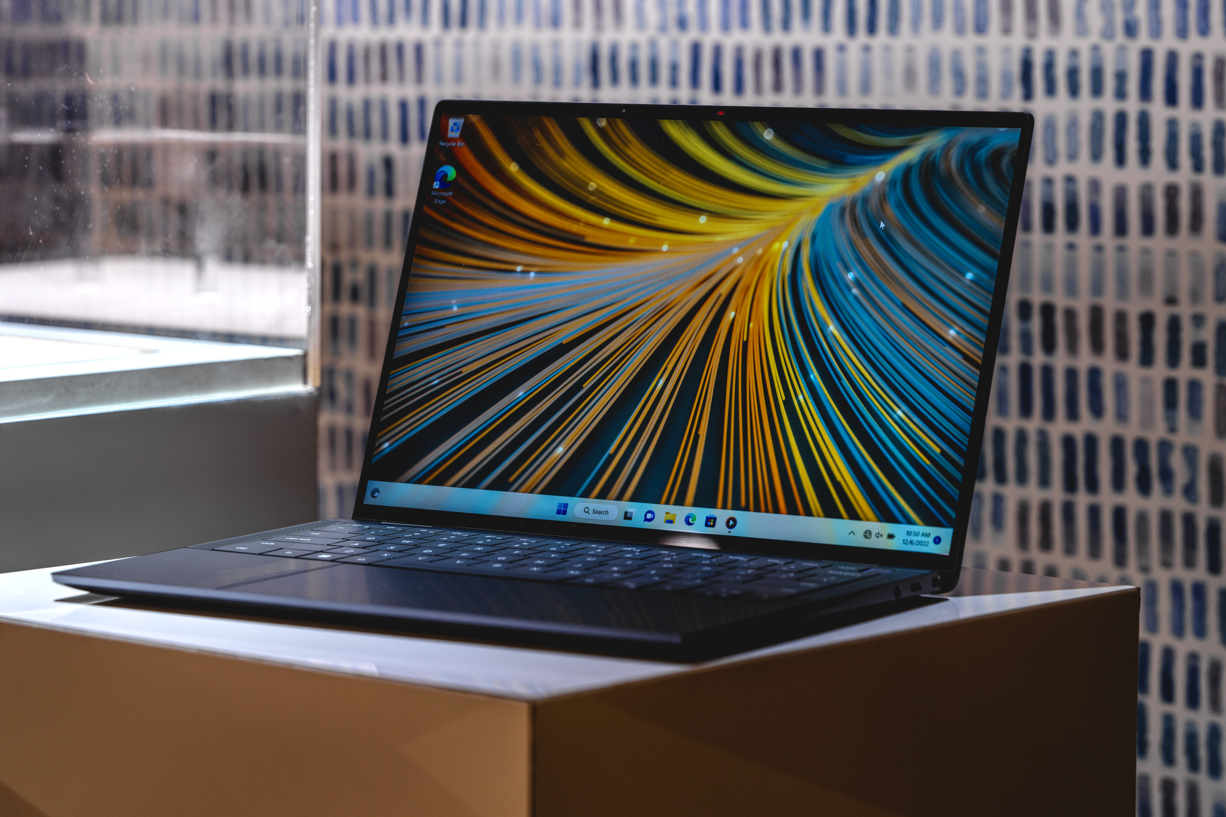 The Dell Latitude 9440 in front of a tiled background.