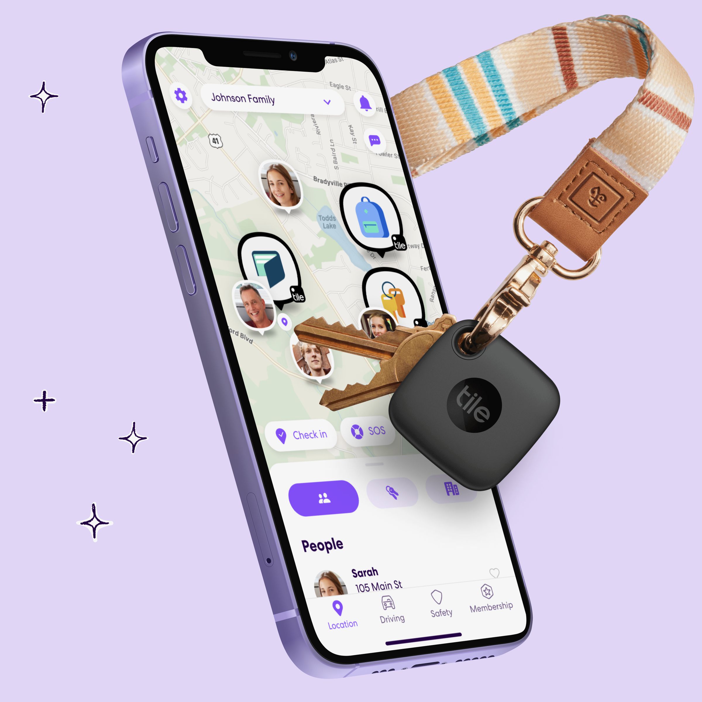 Life360 map view is running on a purple iPhone 12 and shows the locations of four people, a wallet, a bag, and another object. A keychain with two bronze keys are floating next to the iPhone with a pink lanyard, and attached to the ring is a square Tile tracker. Background is a solid light purple with pencil four-point star drawings.