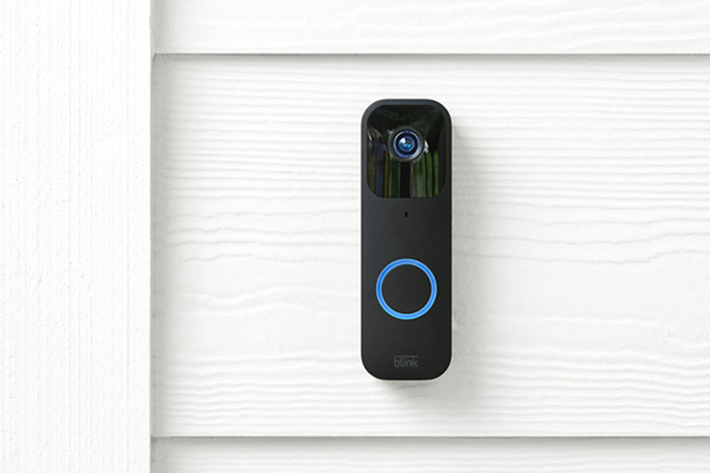 Blink video doorbell mounted on house