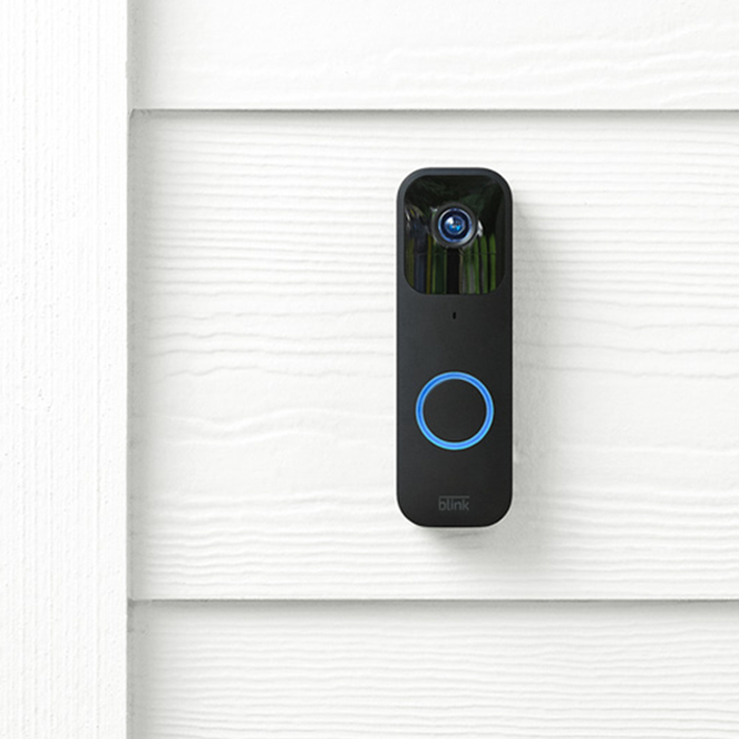Blink video doorbell mounted on house