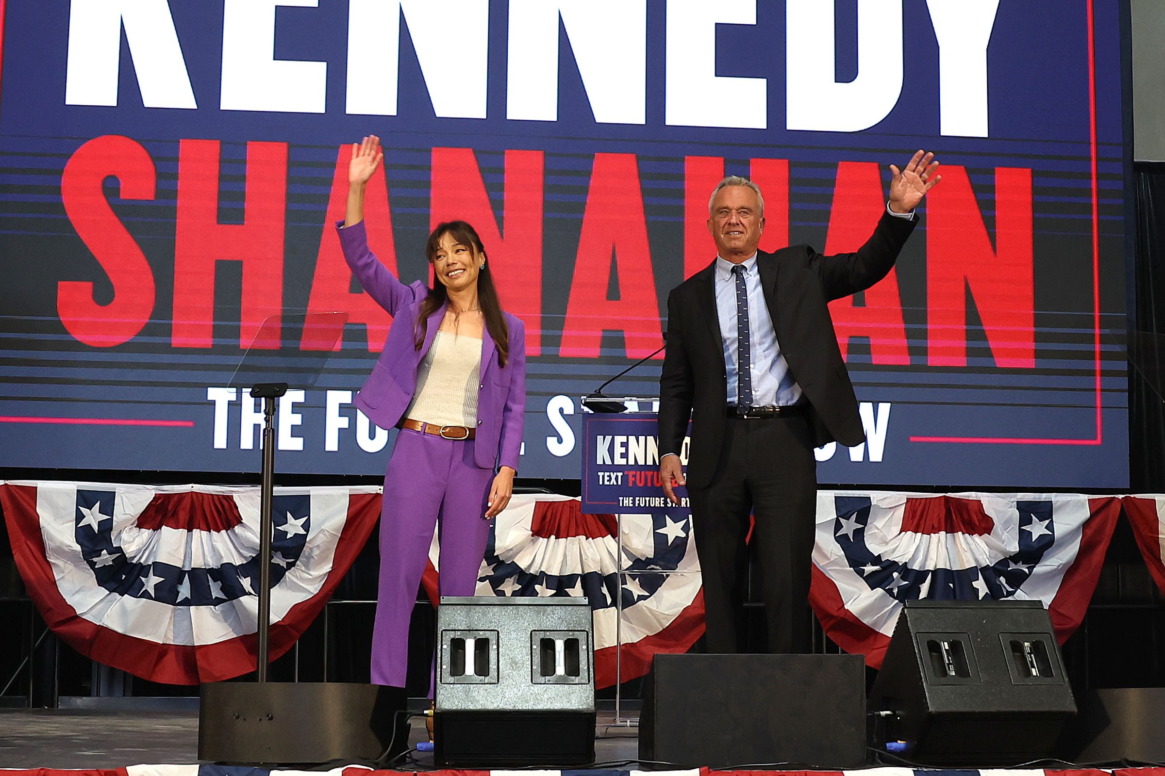Independent presidential candidate Robert F. Kennedy Jr. (R) and his vice presidential pick Nicole Shanahan take the stage during a campaign event to announce his pick for a running mate at the Henry J. Kaiser Event Center on March 26th, 2024, in Oakland, California.