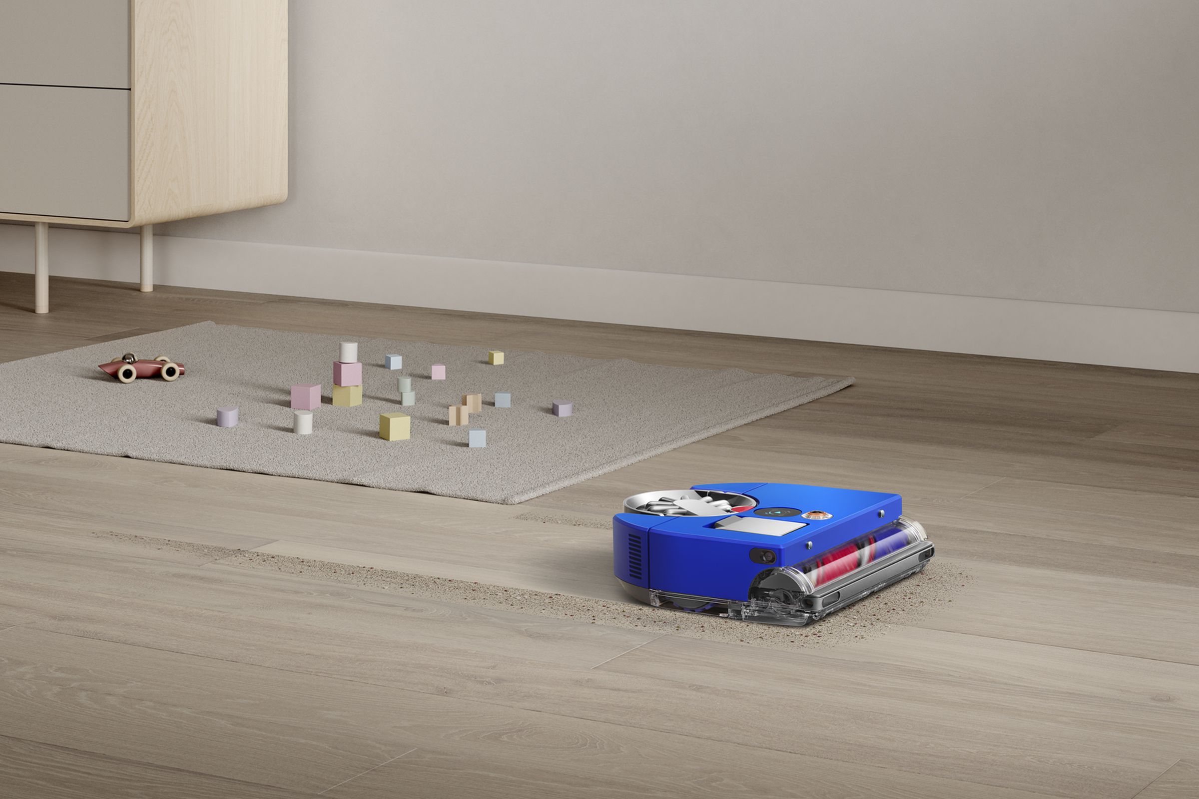 A blue robot vacuum on the floor of a home.